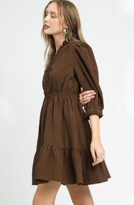 Woman wearing a brown dress on a white background