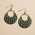 Basil green polka dot Nina leather hoop earrings with a rounded crescent shape.