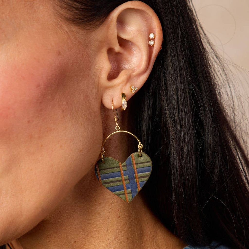 Close-up of Basil green tartan leather heart earrings with a classic plaid pattern.
