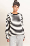 Women's black and white striped knit sweater with crew neckline, relaxed fit, and long sleeves.