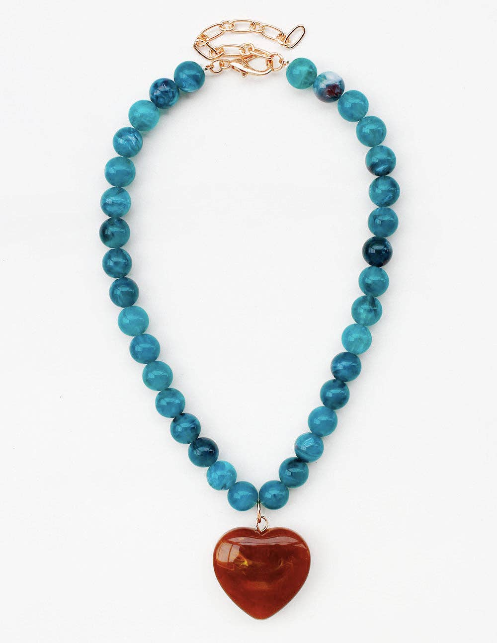 A beaded necklace featuring round turquoise-blue beads and a polished reddish-brown heart-shaped pendant, finished with a gold-tone clasp, shown on a plain white background.