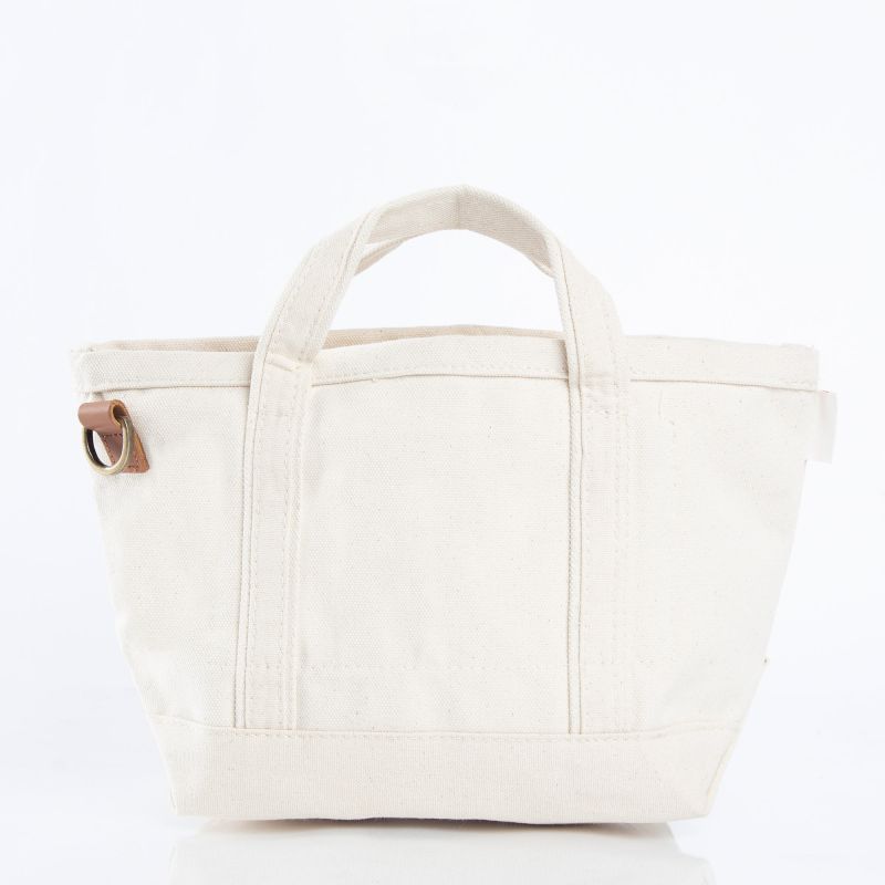 White tote bag with a brown leather strap on a white background