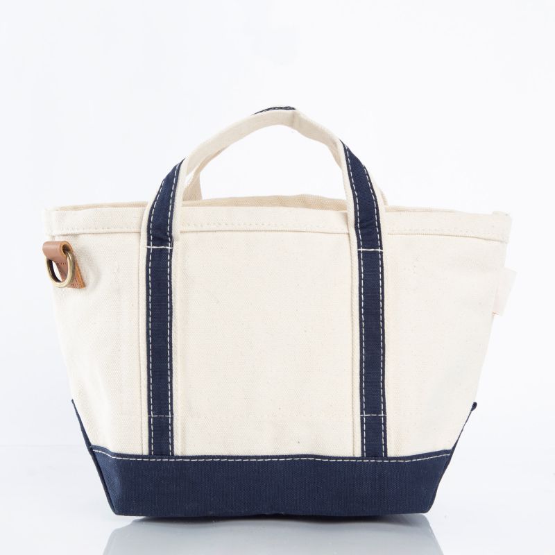 A canvas tote bag with an off-white body, dark navy blue handles and base, and white contrast stitching, shown on a clean white background.