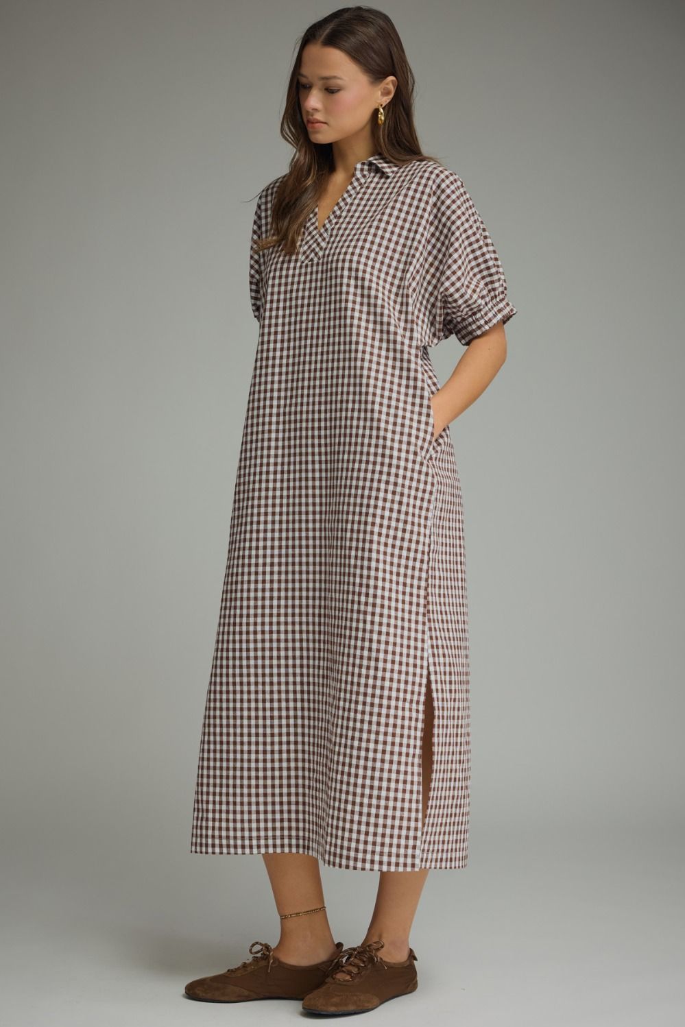 Side view of the gingham midi dress featuring side pockets, side slits, and a flattering relaxed silhouette.