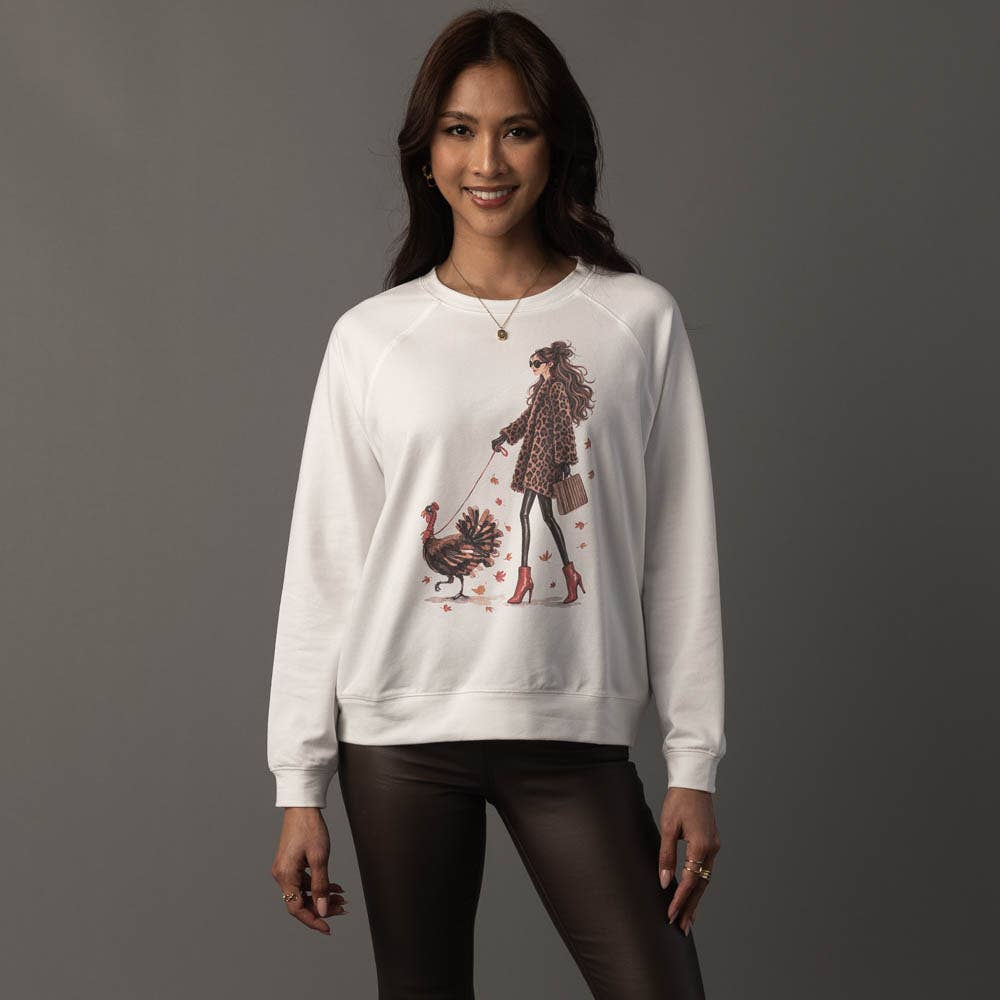 Girl Walking a Turkey Sweatshirt in white with seasonal graphic.