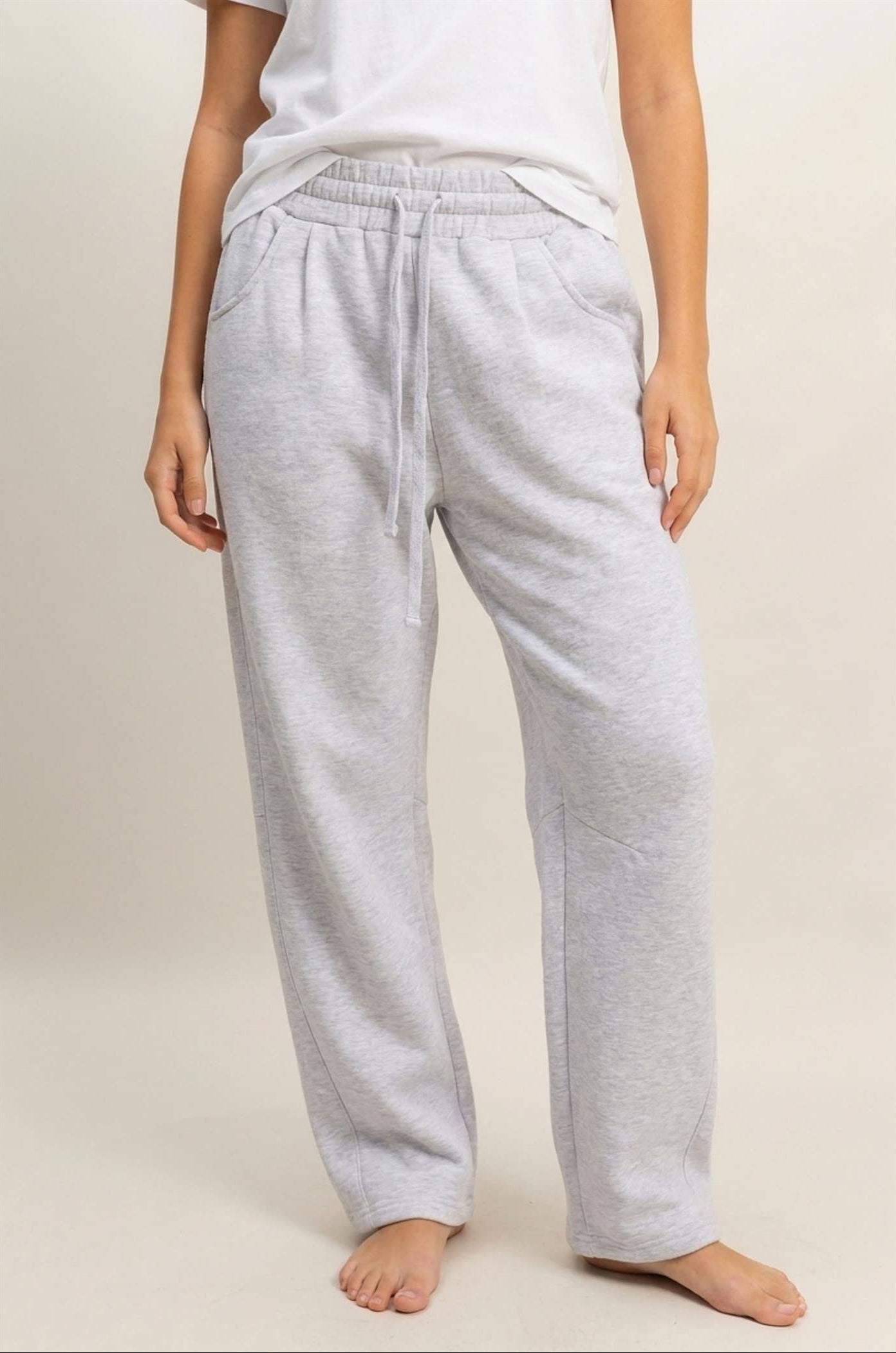 Women's heather gray drawstring waist barrel sweatpants with relaxed fit, elastic waistband, and functional side pockets.