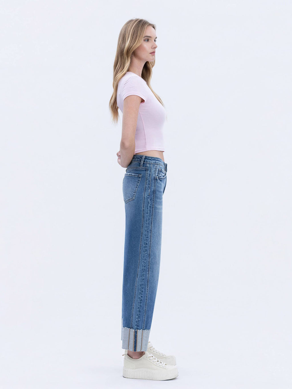 Side profile of cropped barrel leg jeans with a cuffed hem made from comfort stretch denim.