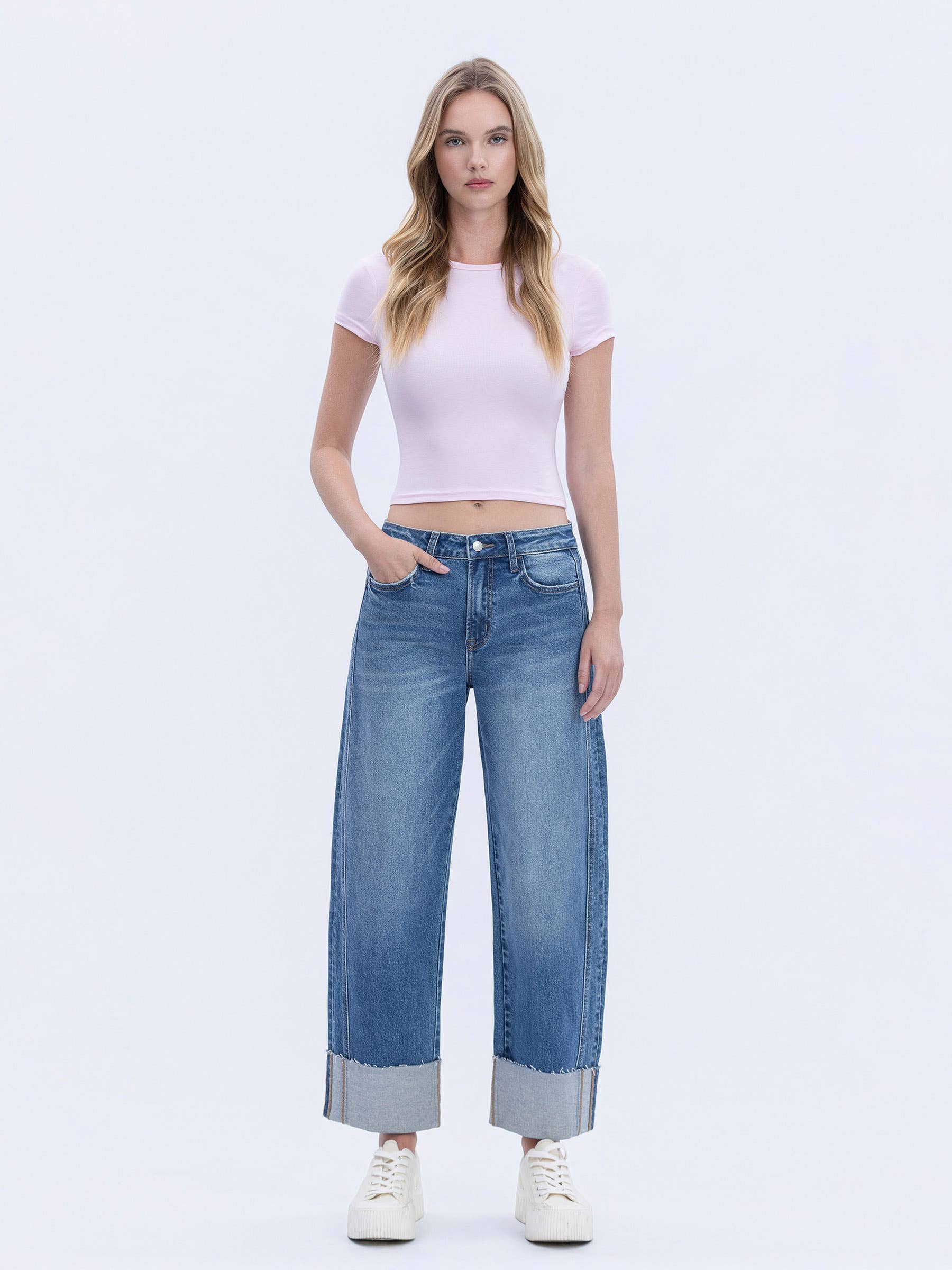 Women's high-rise cuffed barrel leg jeans in a medium wash featuring comfort stretch denim and a cropped length.