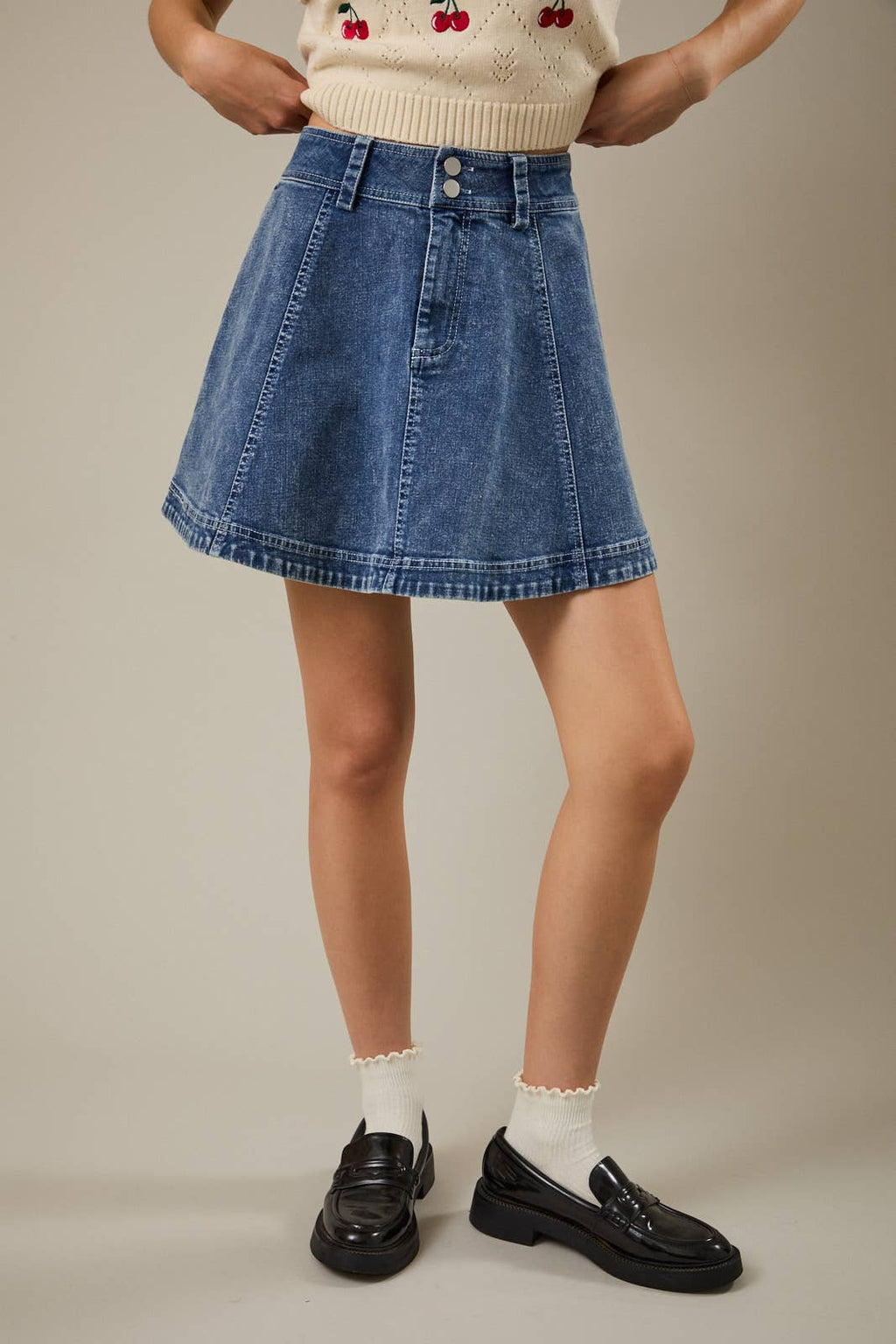Women's high waist flare denim skirt in a medium wash with a flattering A-line silhouette.