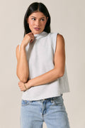 Women's light heather gray mock neck sleeveless top with folded shoulder detail and modern relaxed fit.