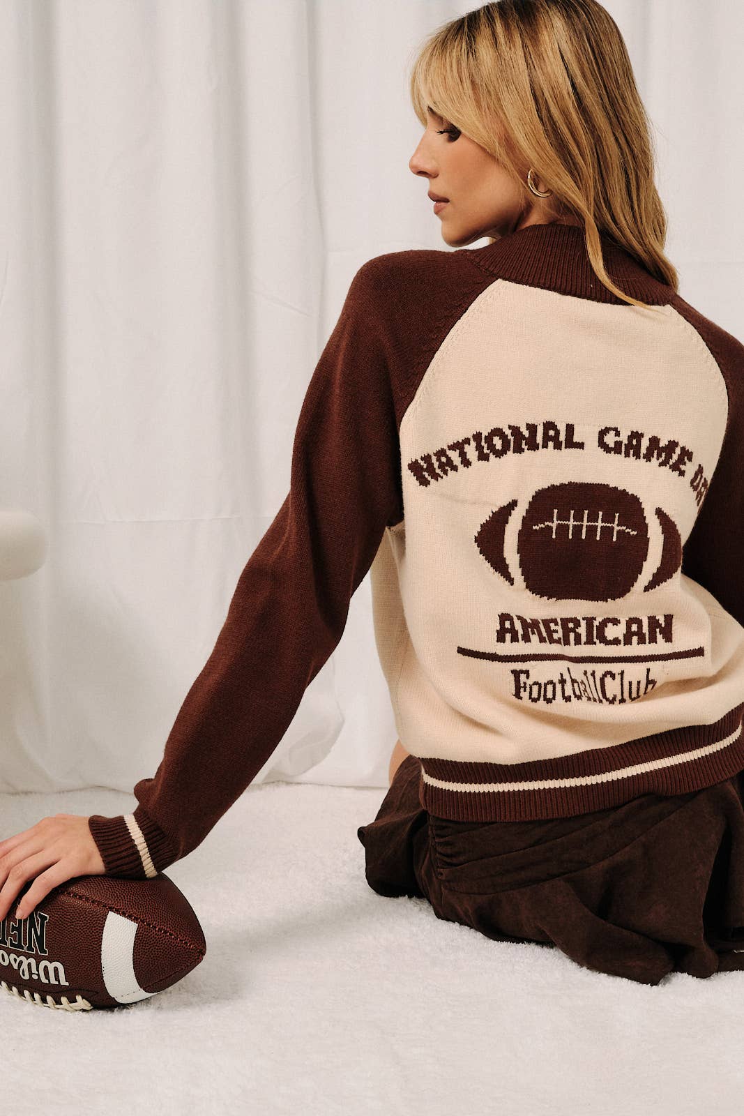 Back view of National Game Day American Football Club cardigan featuring brown varsity lettering and football graphic.