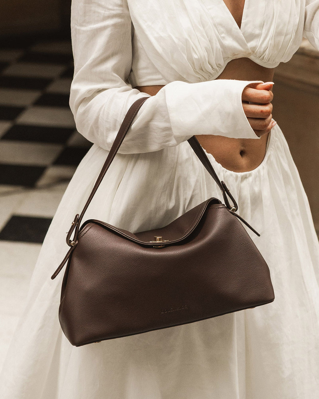 Close-up of the Nicole Chocolate handbag turn-lock closure
