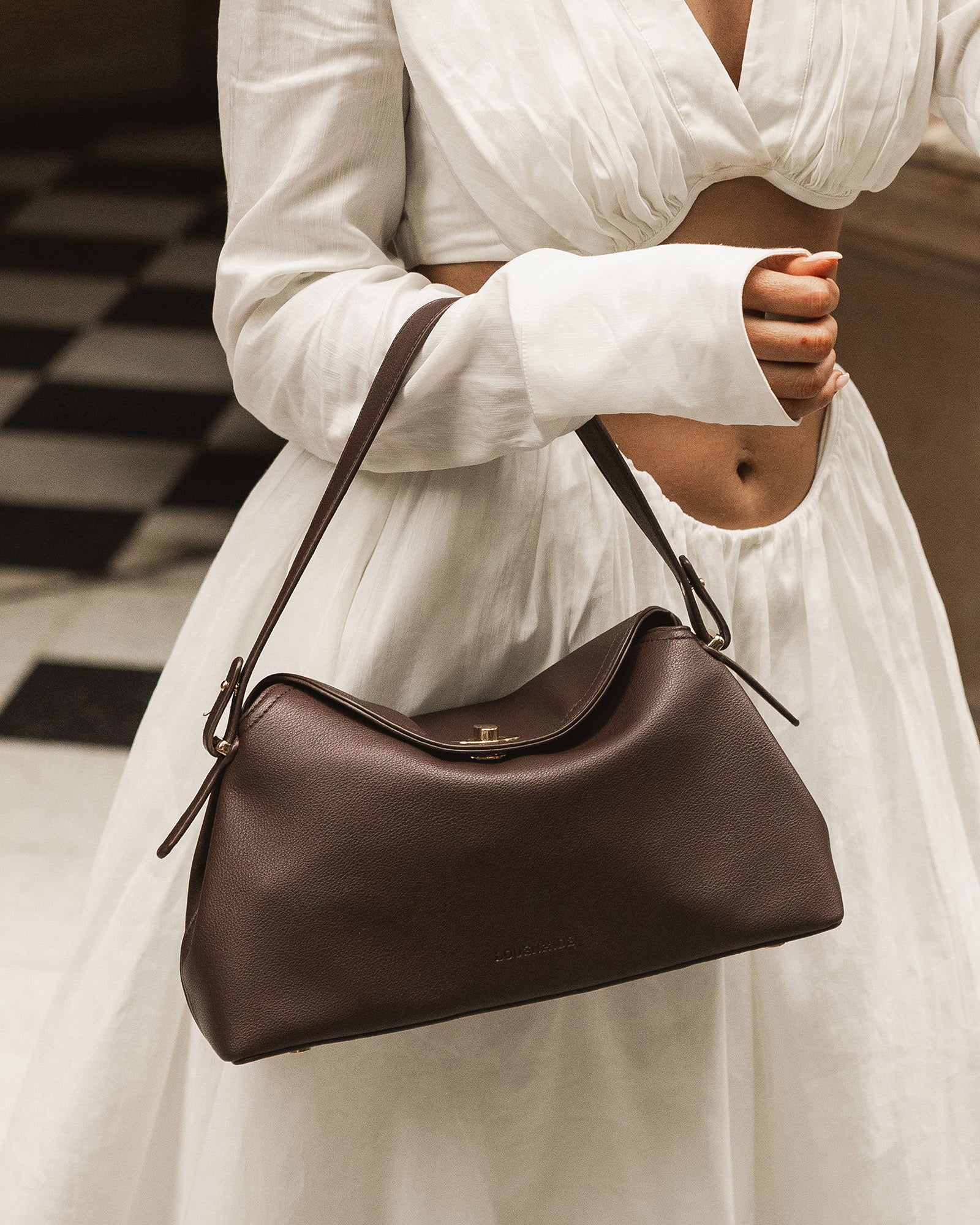 Close-up of the Nicole Chocolate handbag turn-lock closure