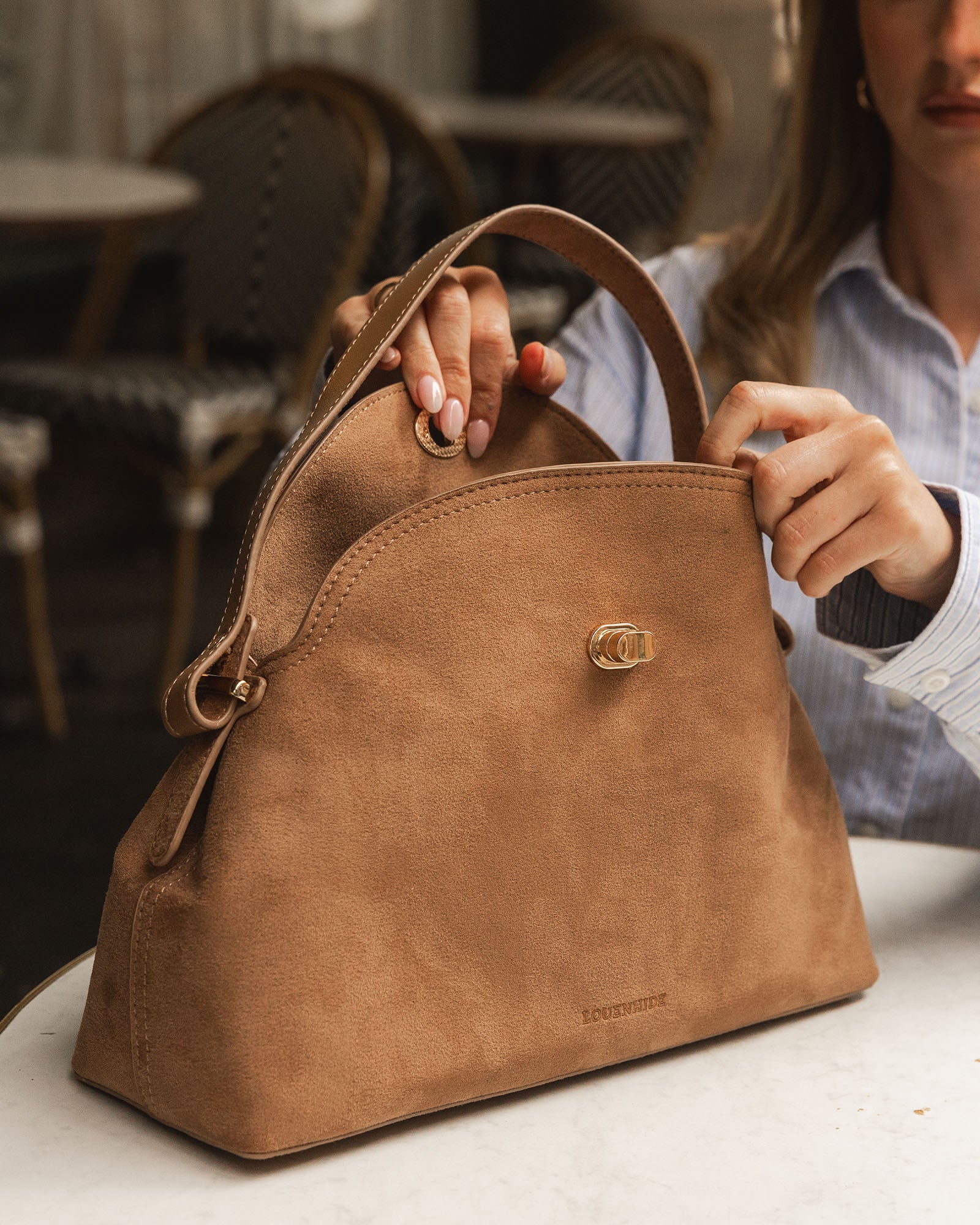 Close-up of the Nicole Suede Honey handbag turn-lock closure
