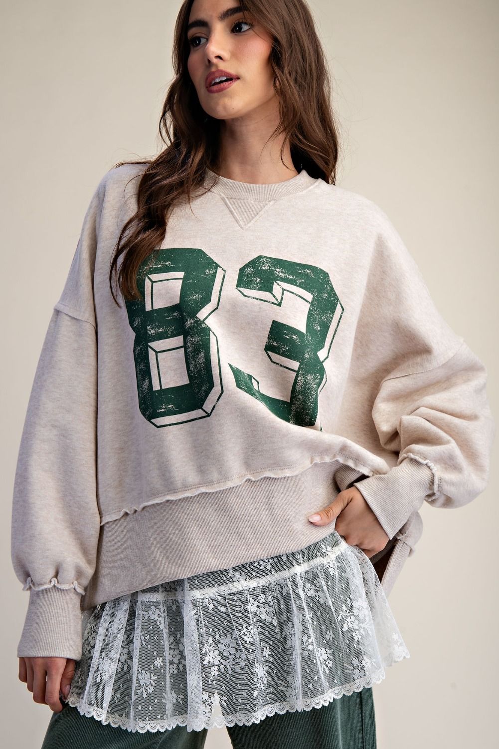 Front view of oversized washed terry knit pullover with 83 number graphic print and relaxed fit.