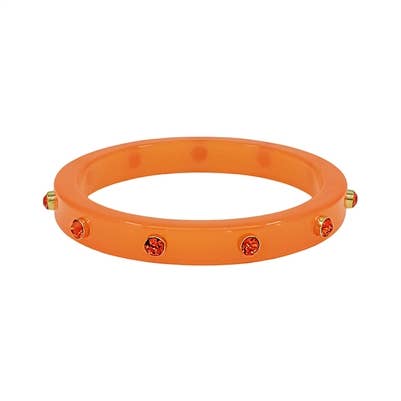 An orange translucent bangle bracelet with small gold-toned studs and red crystal accents, shown on a plain white background.