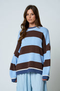 Oversized striped crew neck sweater with light blue and brown pattern.