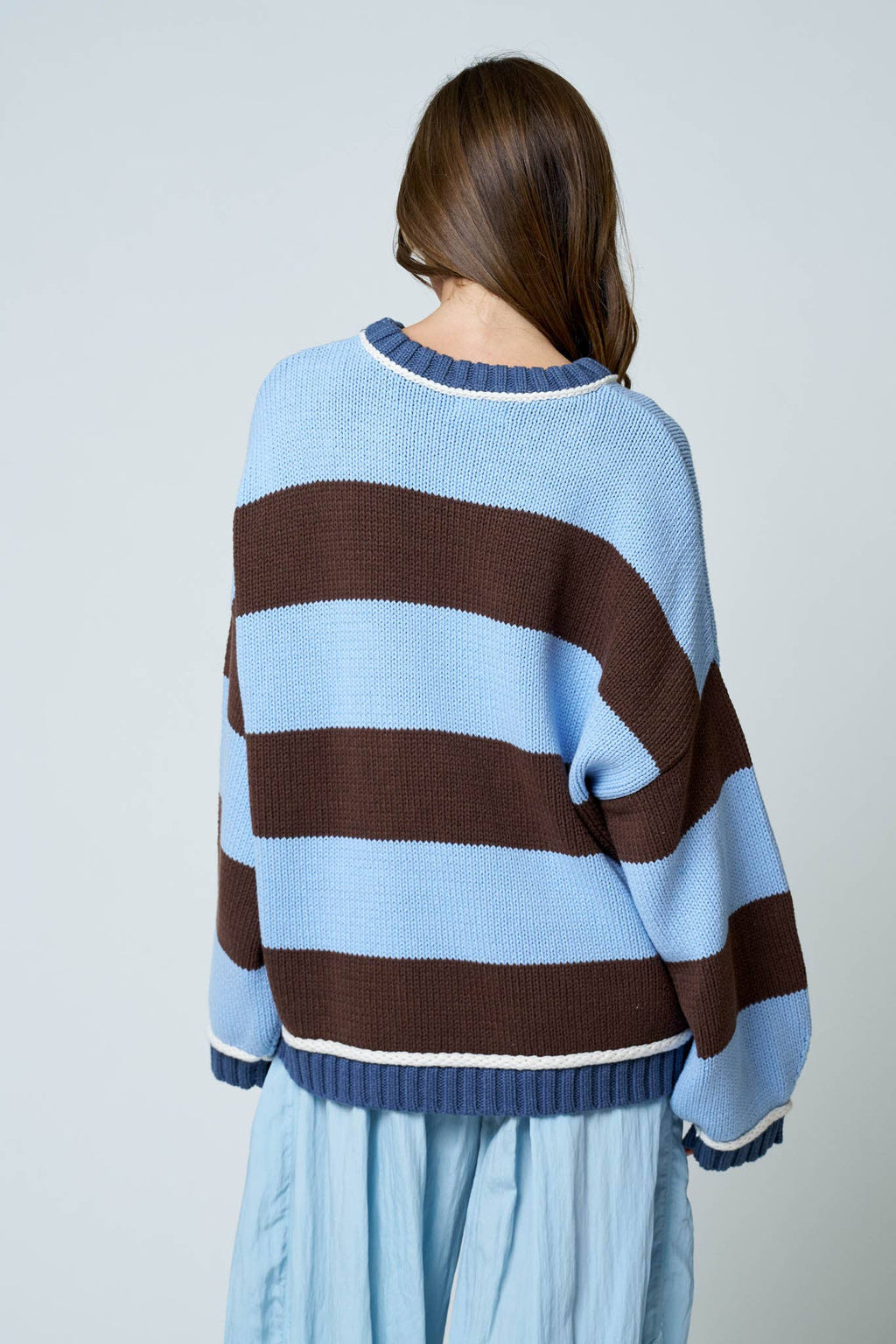Back view of oversized striped knit pullover sweater.