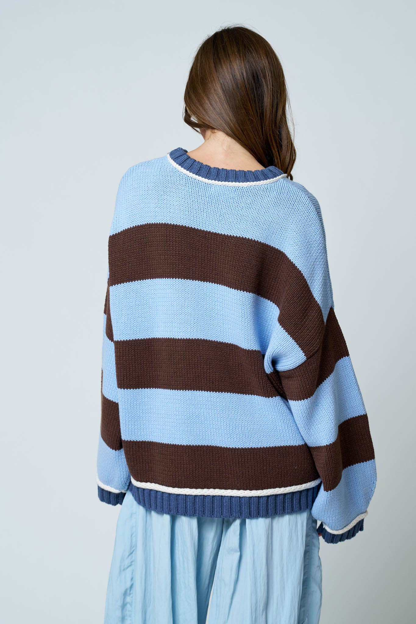 Back view of oversized striped knit pullover sweater.