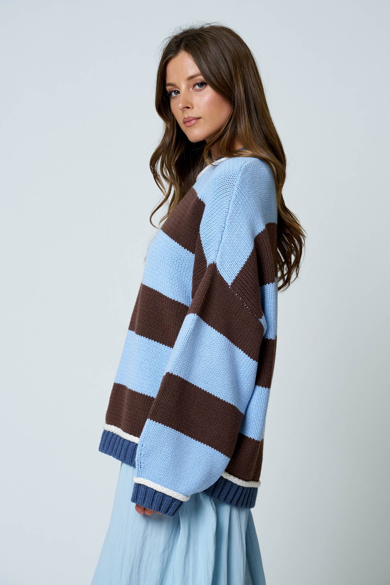 Close-up of blue trim detail on striped oversized sweater.