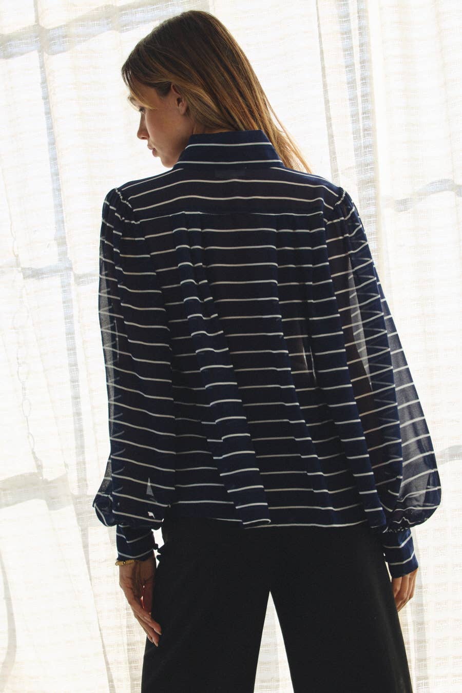 Back view of plus size striped chiffon blouse with relaxed fit.