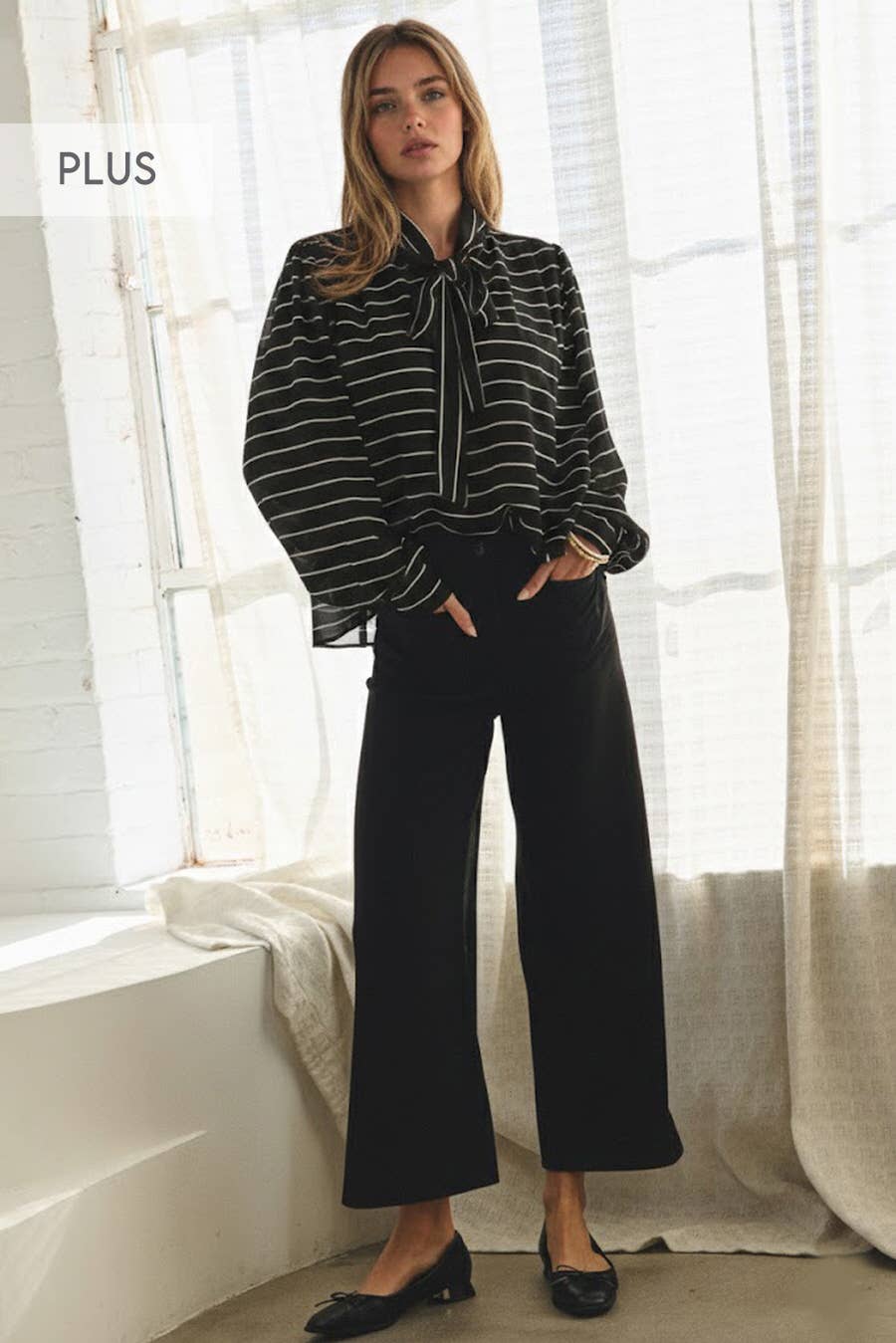 Voluminous sleeve detail on plus size chiffon top.