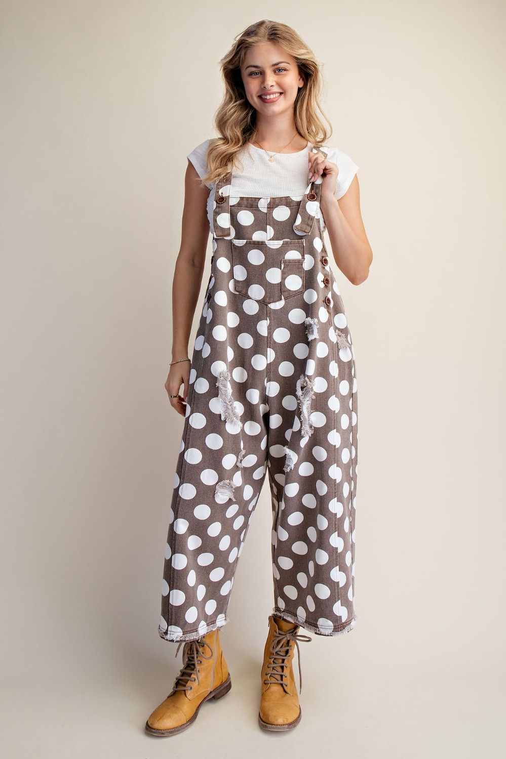 Model wearing mocha brown polka dot overalls with a relaxed wide leg fit and retro-inspired style.