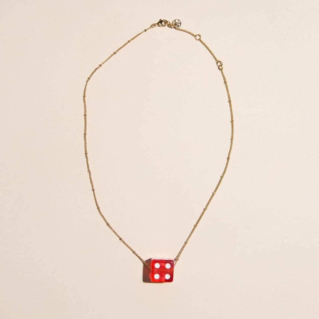 Red vintage dice charm necklace with a playful pendant design on a delicate chain.