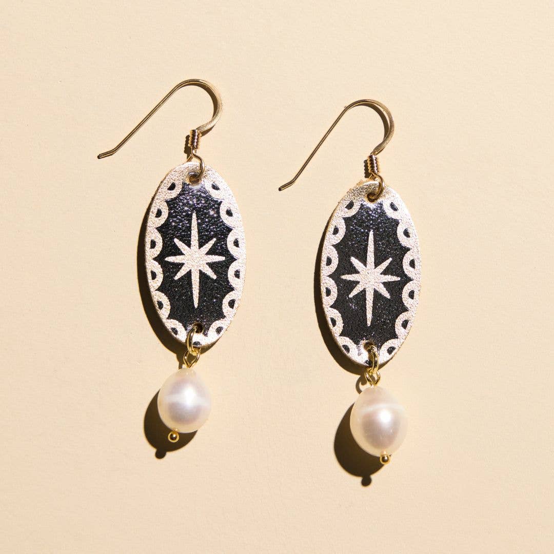Pair of silver satin statement earrings featuring a pearl drop accent.
