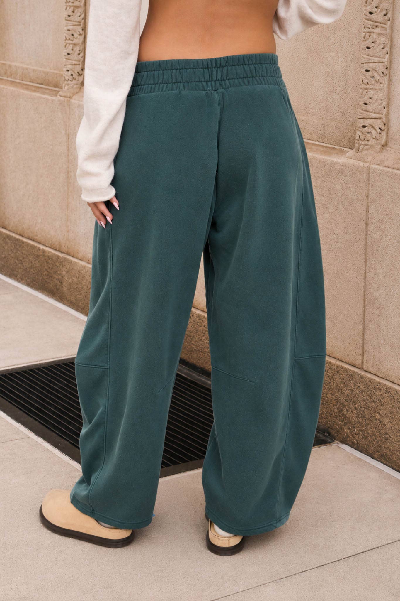Back view of washed dark green relaxed fit sweatpants with a wide leg silhouette.