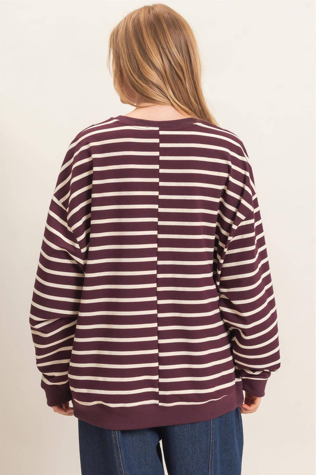 Back view of burgundy and white striped women's pullover with long sleeves and comfortable relaxed fit.