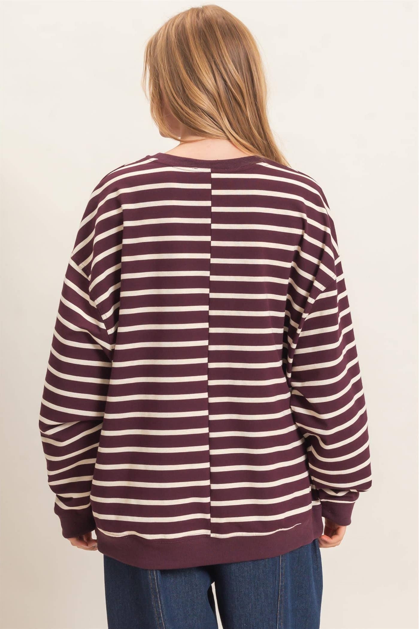Back view of burgundy and white striped women's pullover with long sleeves and comfortable relaxed fit.