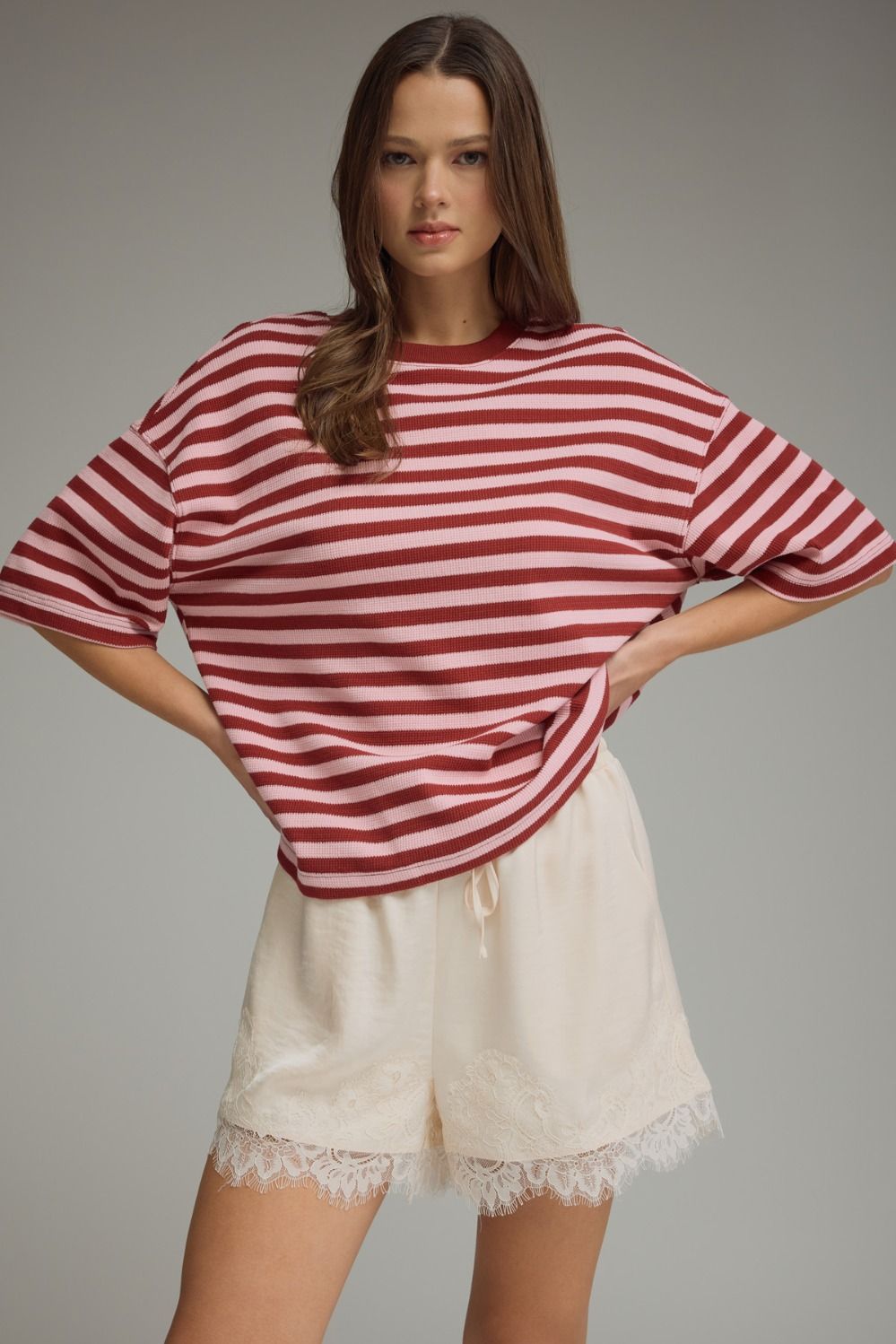Women's burgundy and pink striped ribbed short sleeve top with a round neckline.