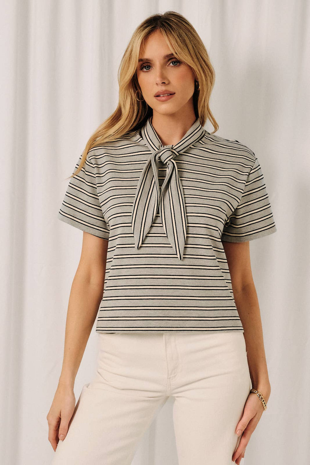 Women's gray navy and white striped top featuring a stylish scarf collar neckline and feminine boutique design.