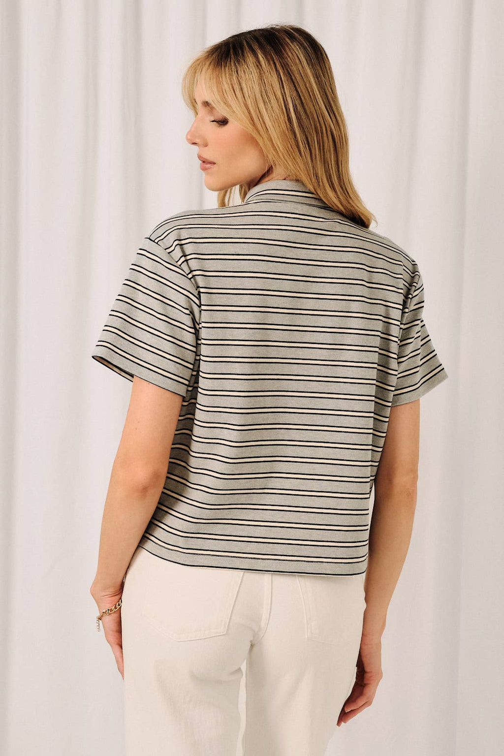Back view of striped scarf collar top showing the relaxed feminine silhouette.