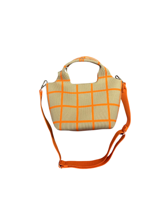 Beige handbag with orange checkered pattern and matching strap on a white background