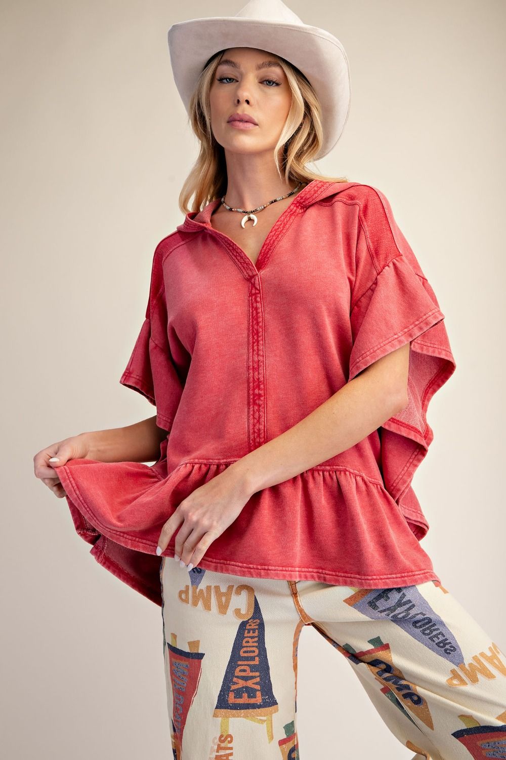 Close-up of the Washed Terry Ruffle Bottom Pullover featuring the mineral wash fabric and hooded neckline.