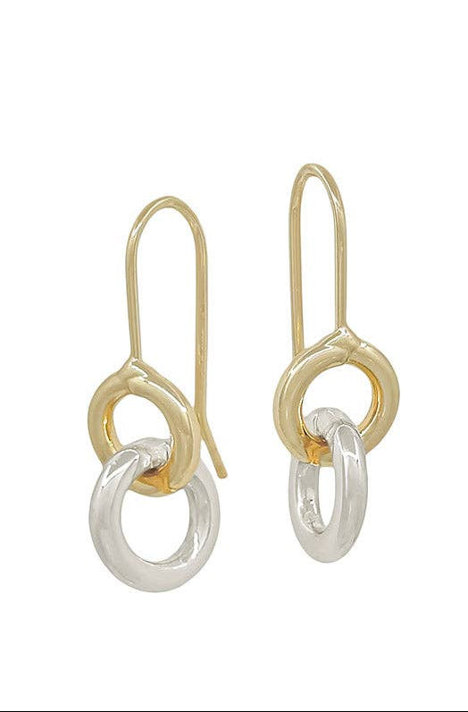 A pair of gold and silver drop earrings displayed next to a white card labeled 'été', with 'Water-Resistant' text at the bottom right.